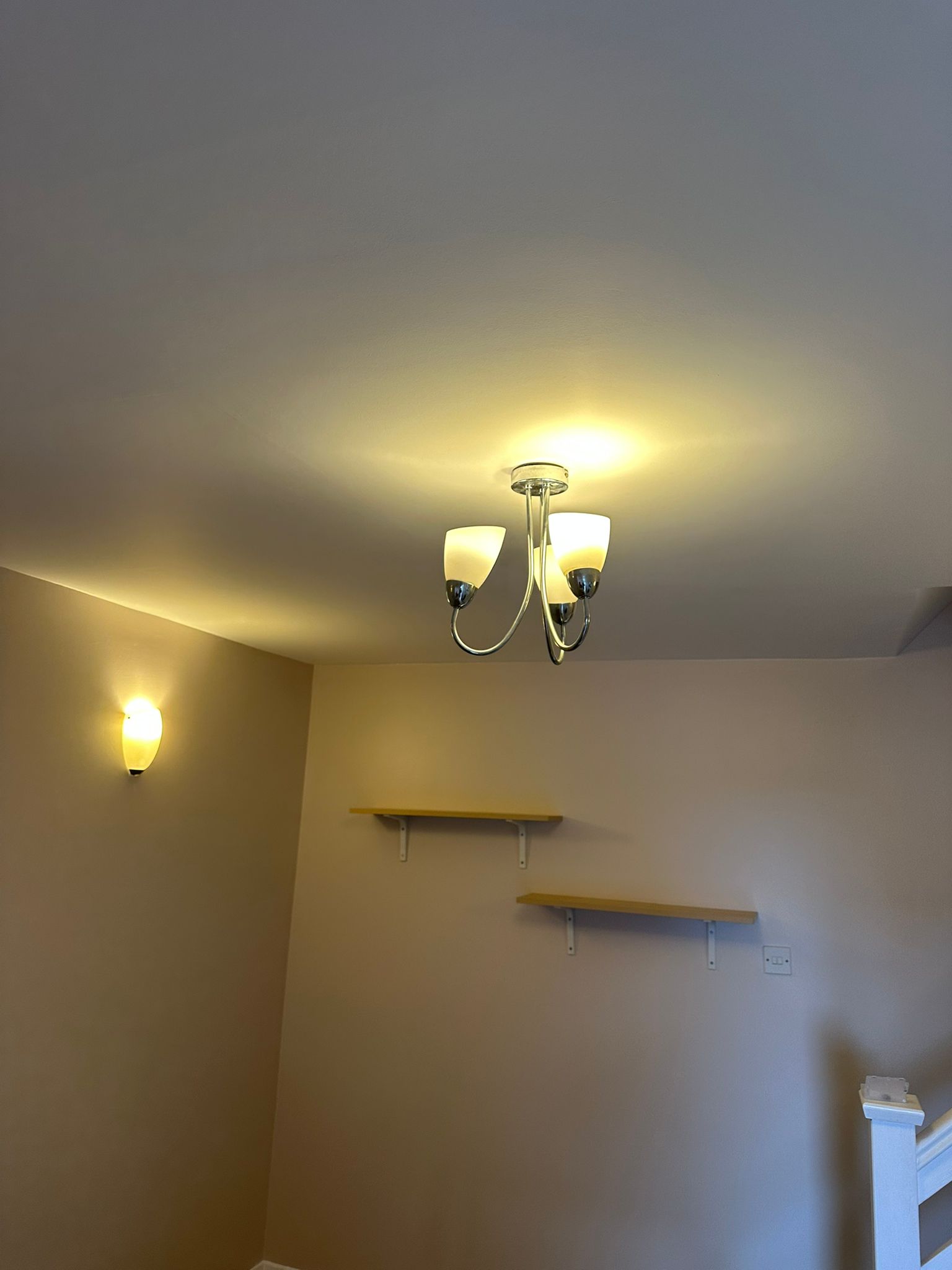 Interior chandelier and wall sconce landing
